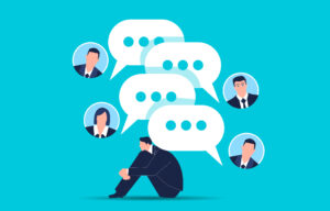 business man hunched under speech bubbles from four people texting